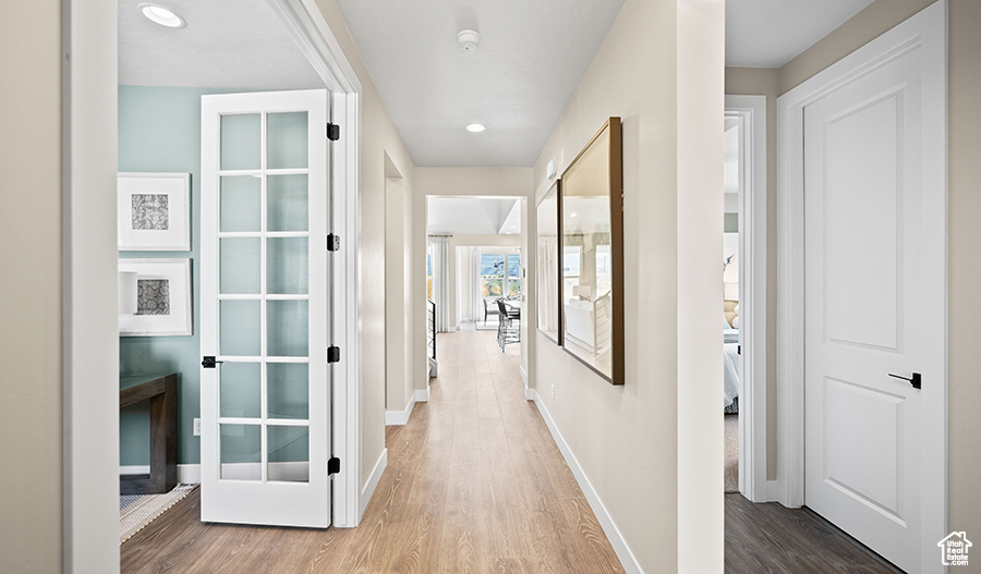 Hall featuring wood finished floors and recessed lighting