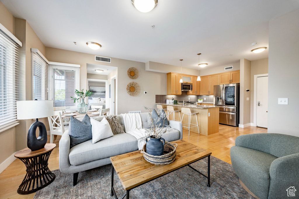 Living room with light wood-type flooring and baseboards