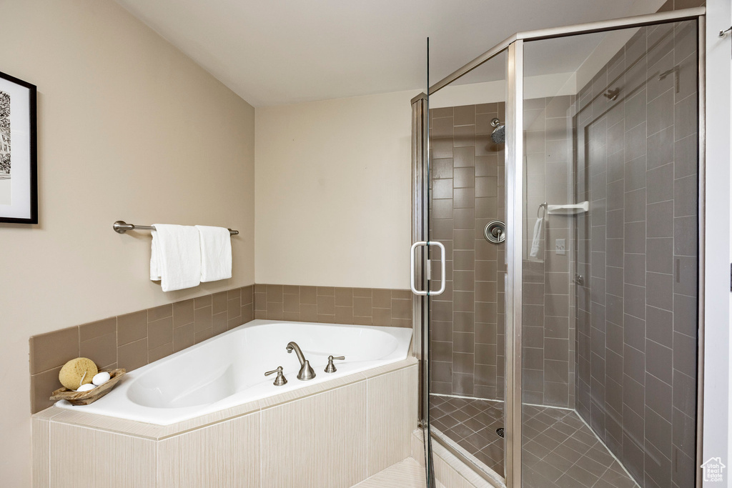 Bathroom with a garden tub and a shower stall