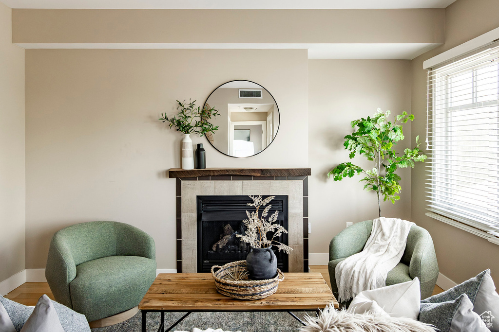 Sitting room featuring wood finished floors and a tile fireplace