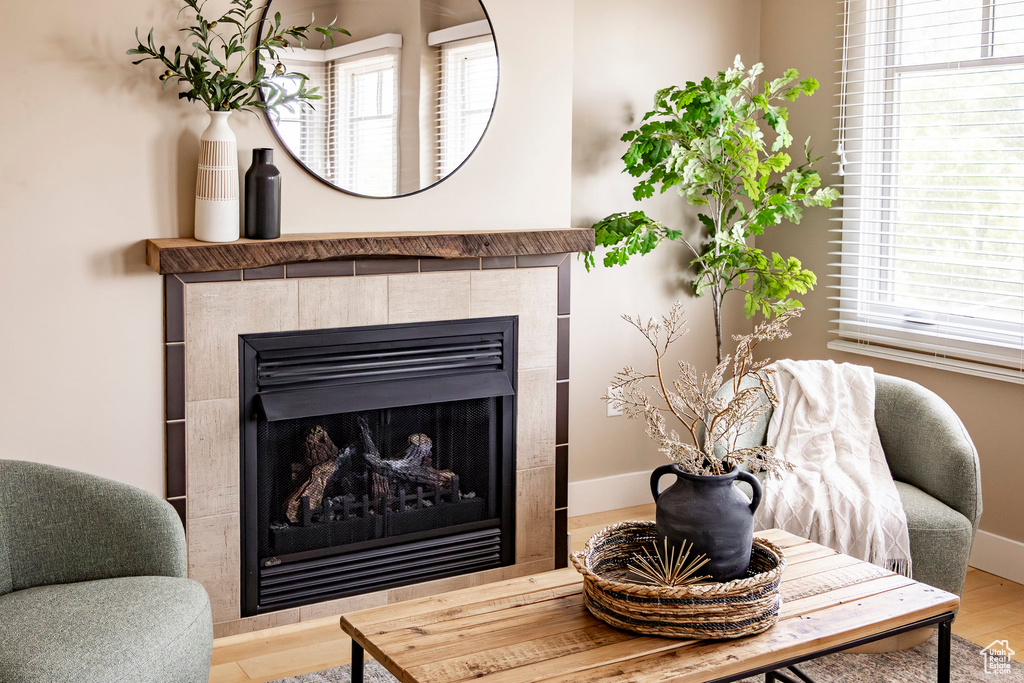 Detailed view of a tile fireplace and wood finished floors