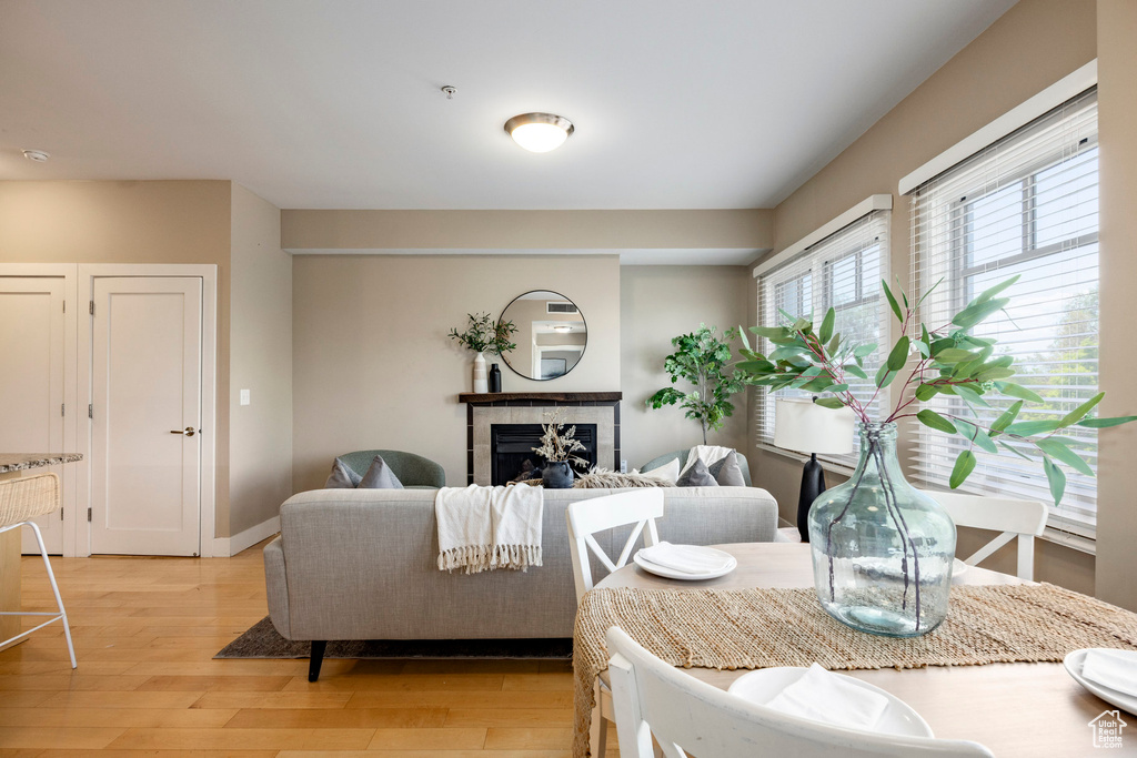 Living area featuring light wood finished floors and a tiled fireplace