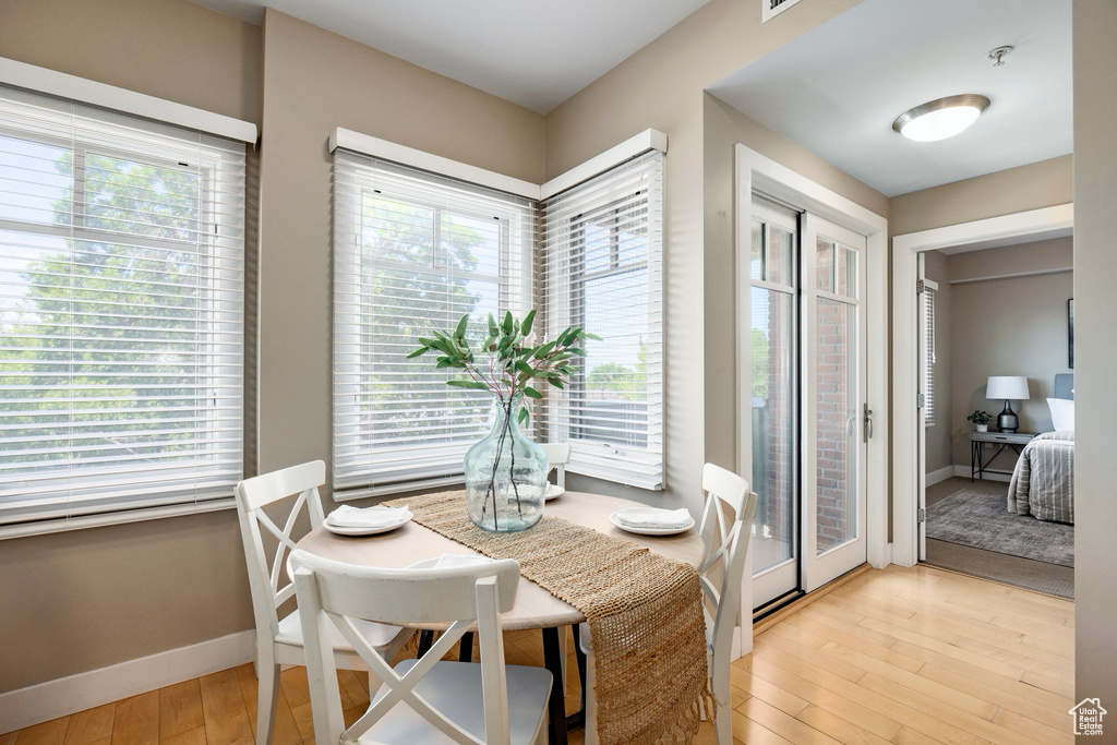 Dining area with light wood-style floors and baseboards