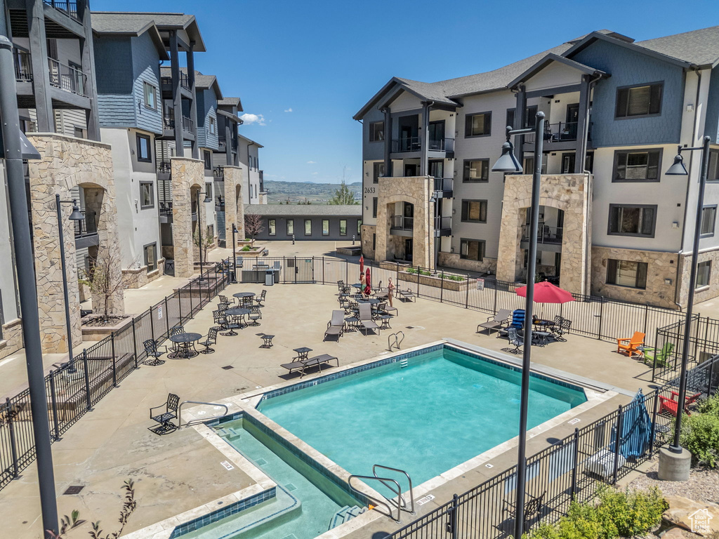 View of pool featuring a pool with connected hot tub and a patio area