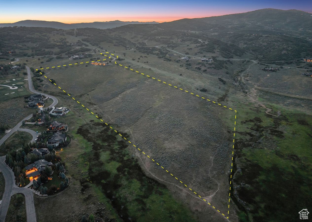 Aerial view at dusk of a mountain view and property parcel outlined