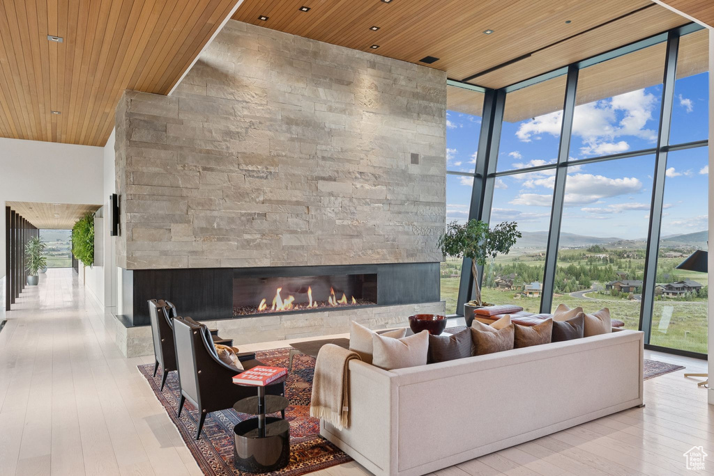 Building lobby featuring wooden ceiling, floor to ceiling windows, and a towering ceiling