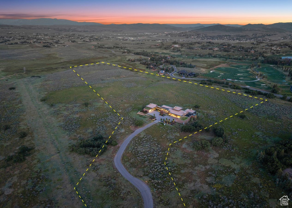 Aerial view at dusk of a mountain view, a view of countryside, and property boundaries highlighted