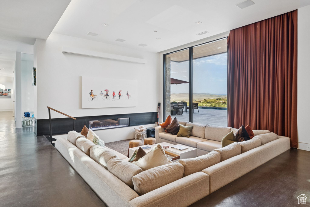 Living room with expansive windows and concrete floors
