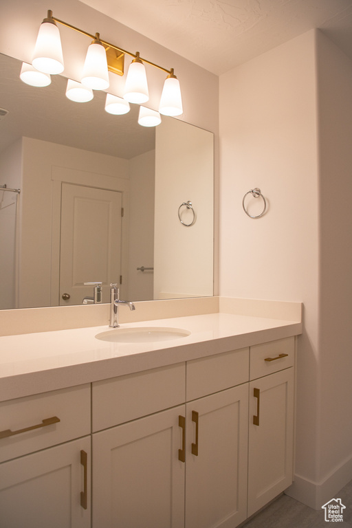 Bathroom featuring vanity and baseboards