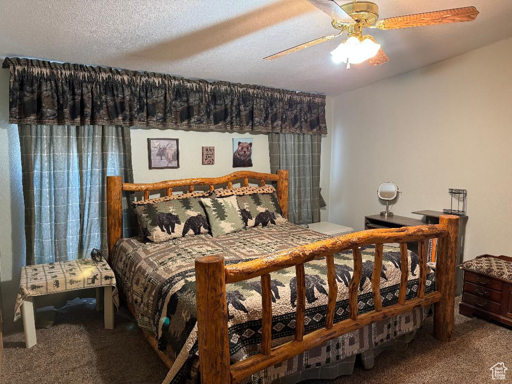 Carpeted bedroom with ceiling fan