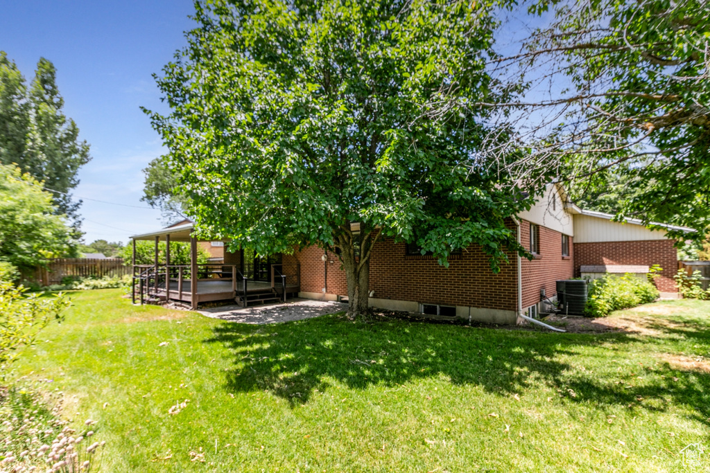 View of yard with a patio and a deck