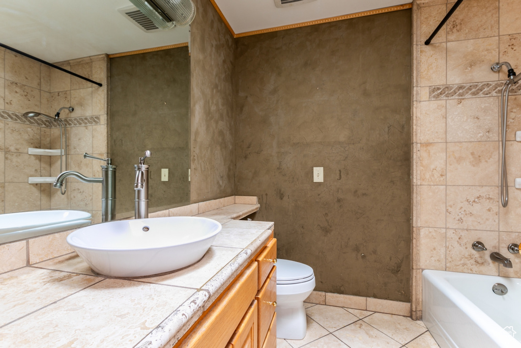 Full bath featuring tile patterned floors, vanity, and shower / washtub combination
