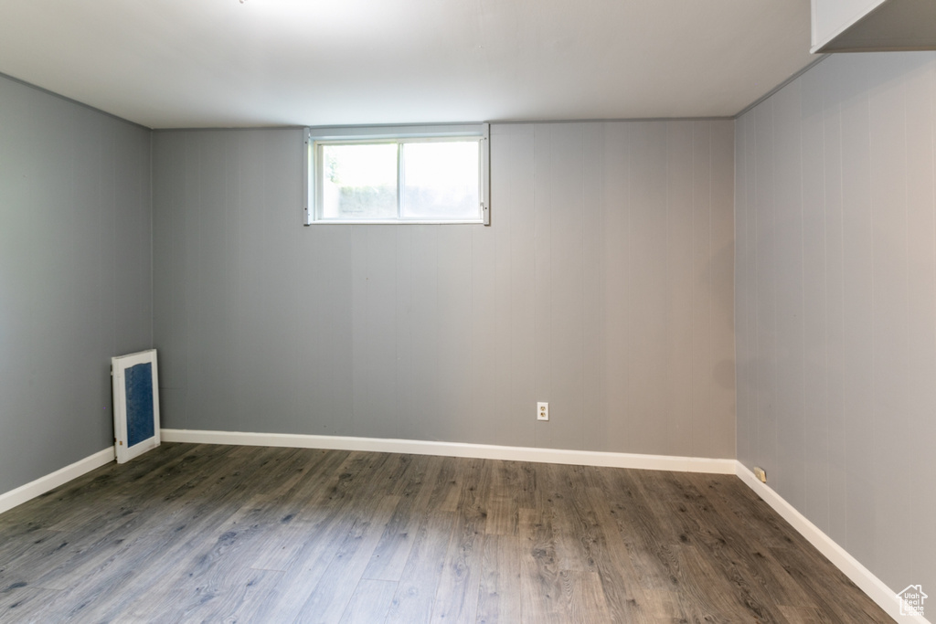 Unfurnished room with wood finished floors and baseboards