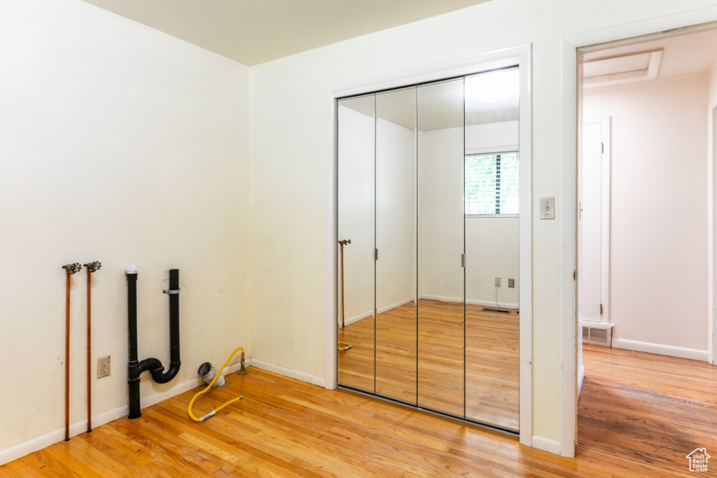 Unfurnished bedroom featuring light wood-type flooring and a closet