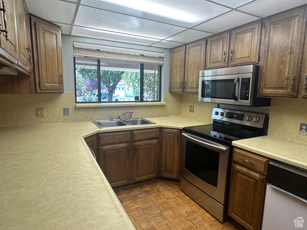 Kitchen with appliances with stainless steel finishes, light countertops, and tasteful backsplash