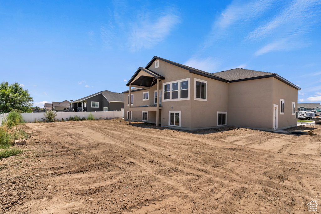 Rear view of house featuring stucco siding