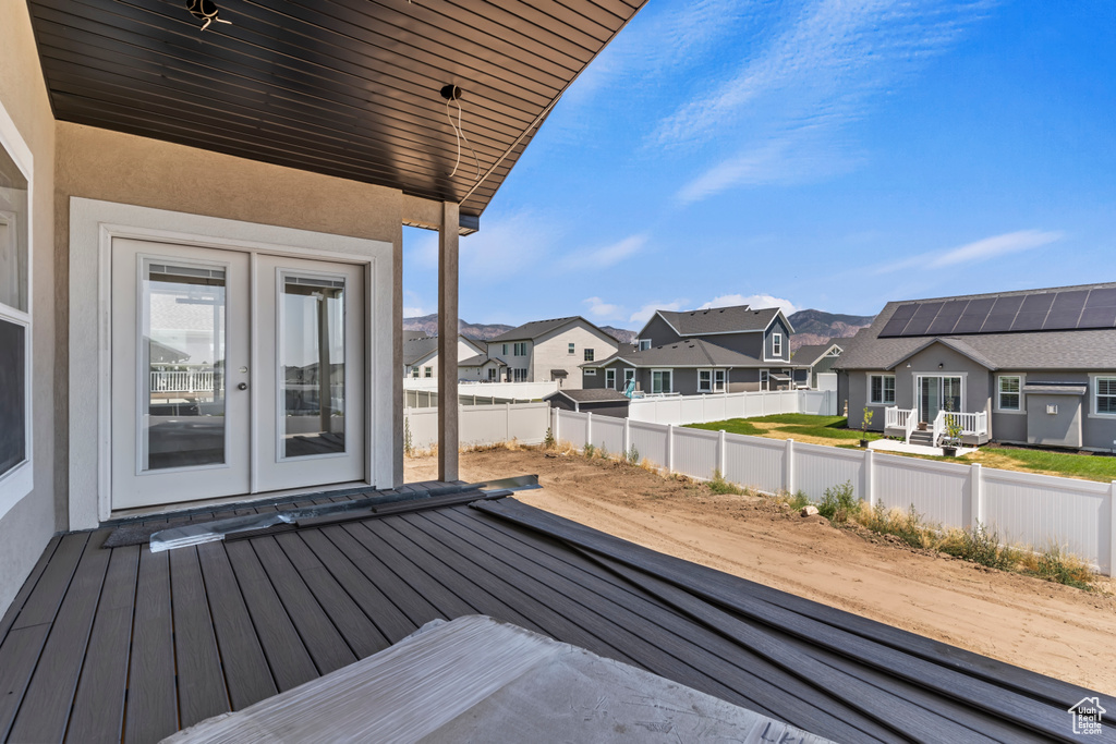 Wooden terrace with a residential view and french doors