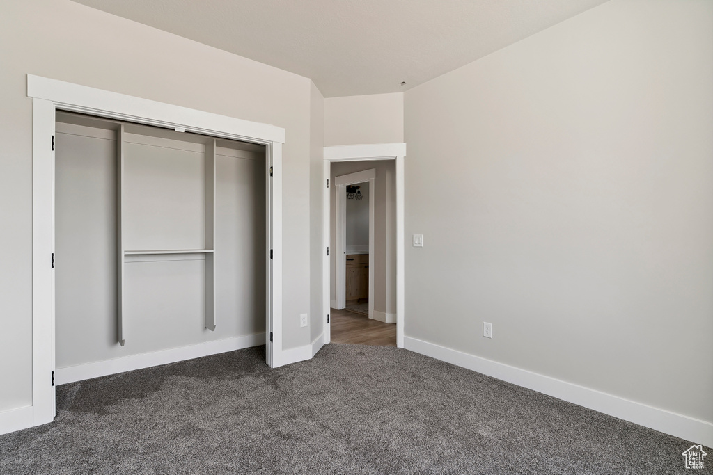 Unfurnished bedroom with carpet and a closet