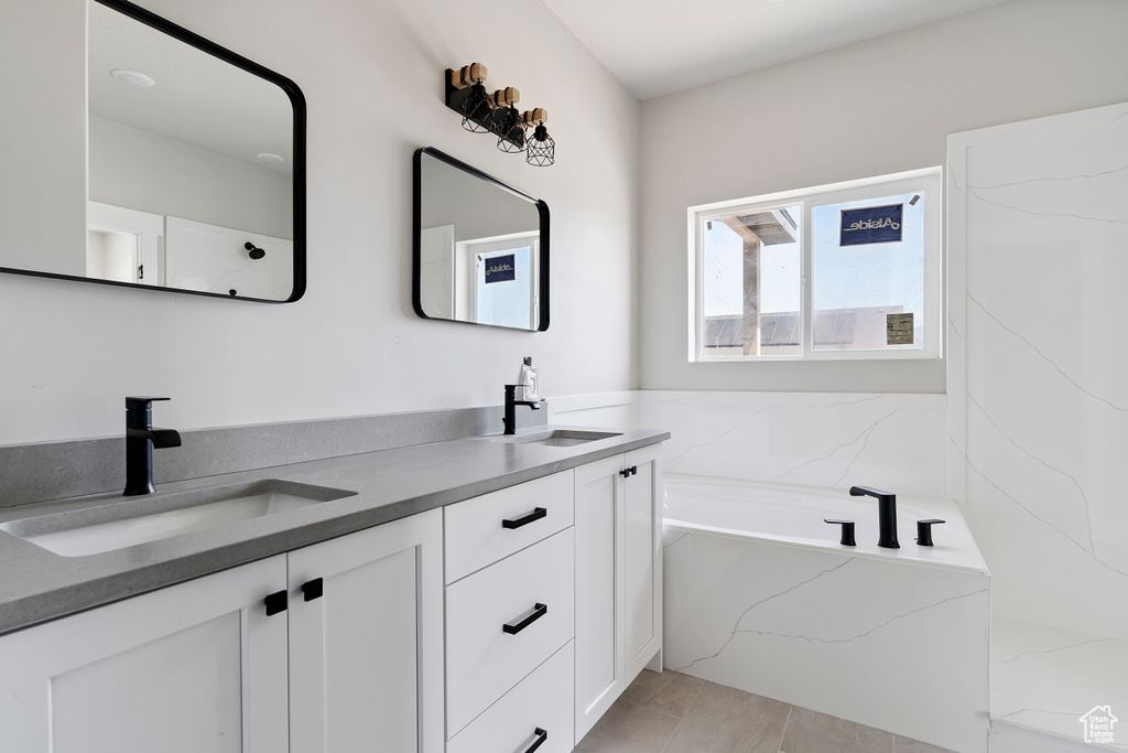 Full bathroom with double vanity and a bath