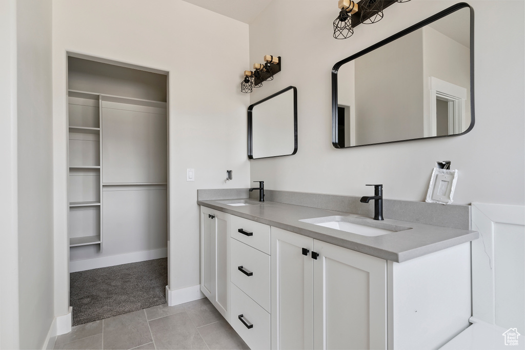 Full bath featuring double vanity and tile patterned floors