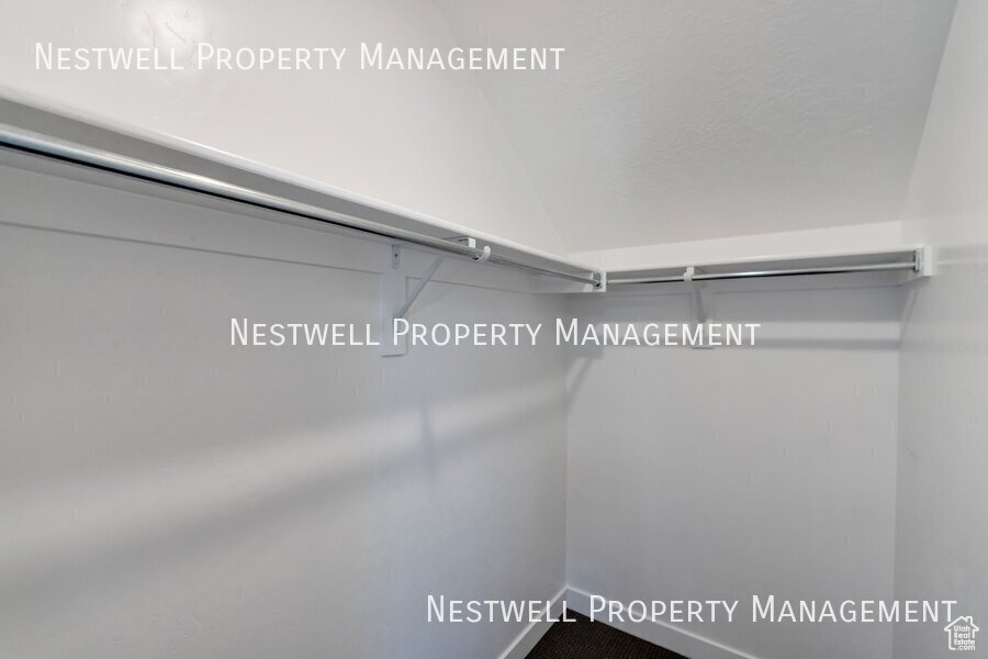 Walk in closet with vaulted ceiling
