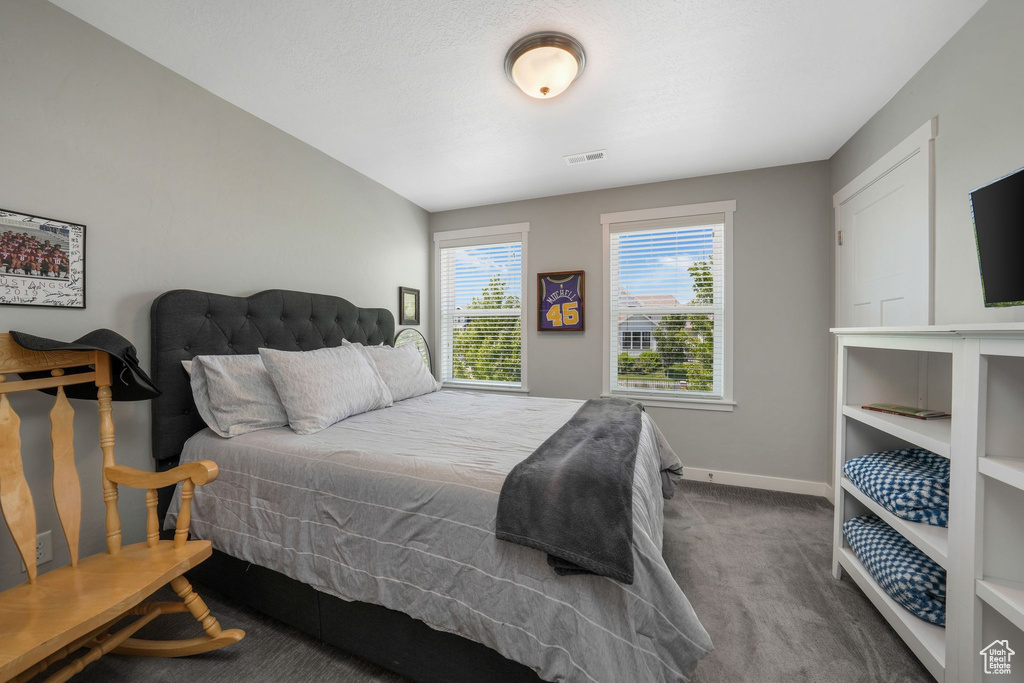 Carpeted bedroom featuring baseboards