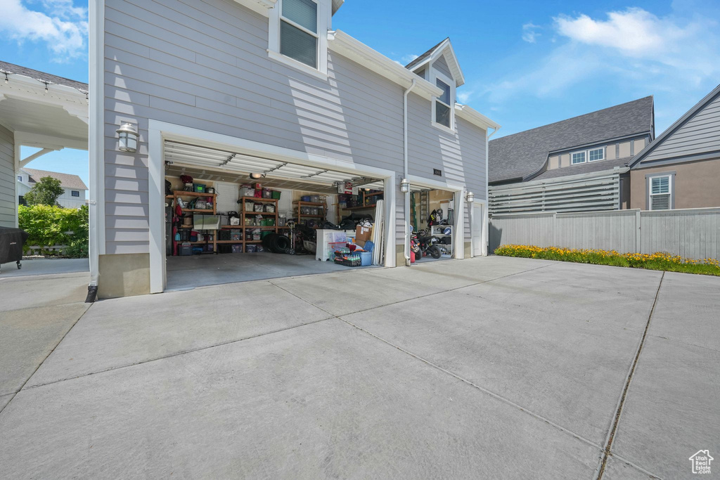 View of side of home featuring concrete driveway