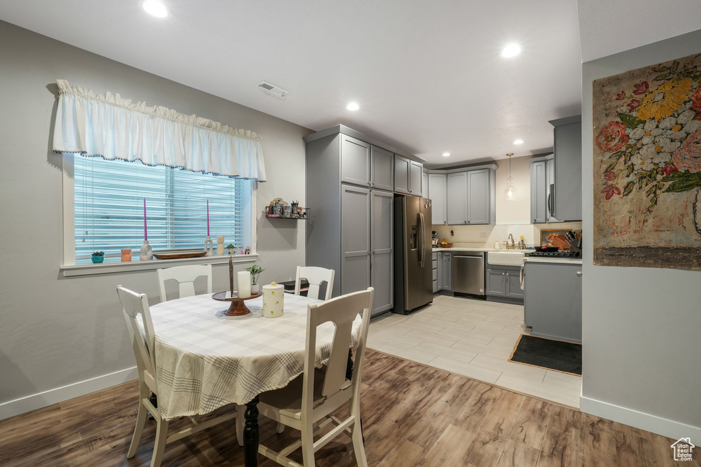 Dining area with recessed lighting and light wood-style flooring