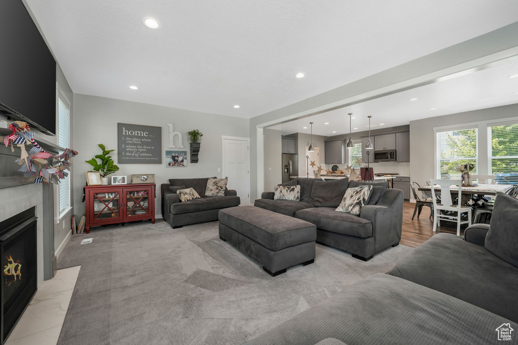 Living area featuring recessed lighting and a fireplace