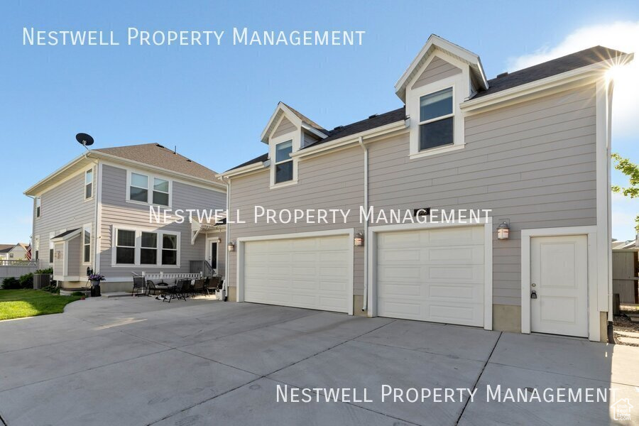 View of front of home featuring an attached garage and driveway