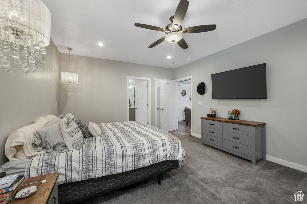 Carpeted bedroom with a chandelier, recessed lighting, and ceiling fan