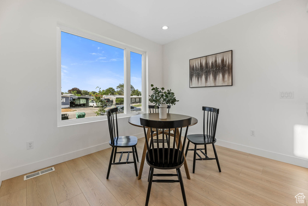 Dining space featuring light wood finished floors and recessed lighting
