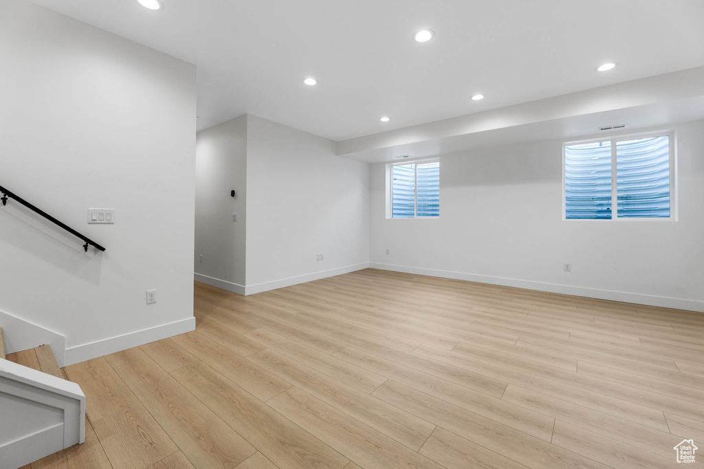Unfurnished room with recessed lighting, light wood-type flooring, and stairs