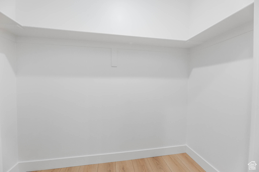 Spacious closet with light wood finished floors