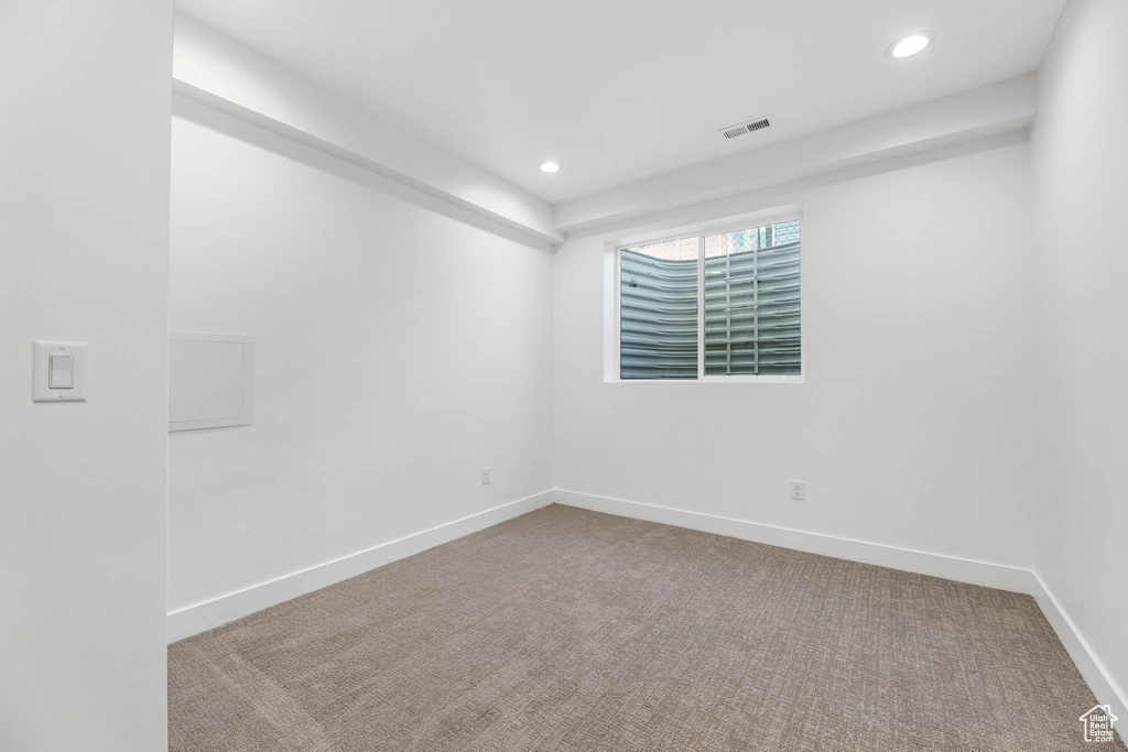 Carpeted spare room with recessed lighting