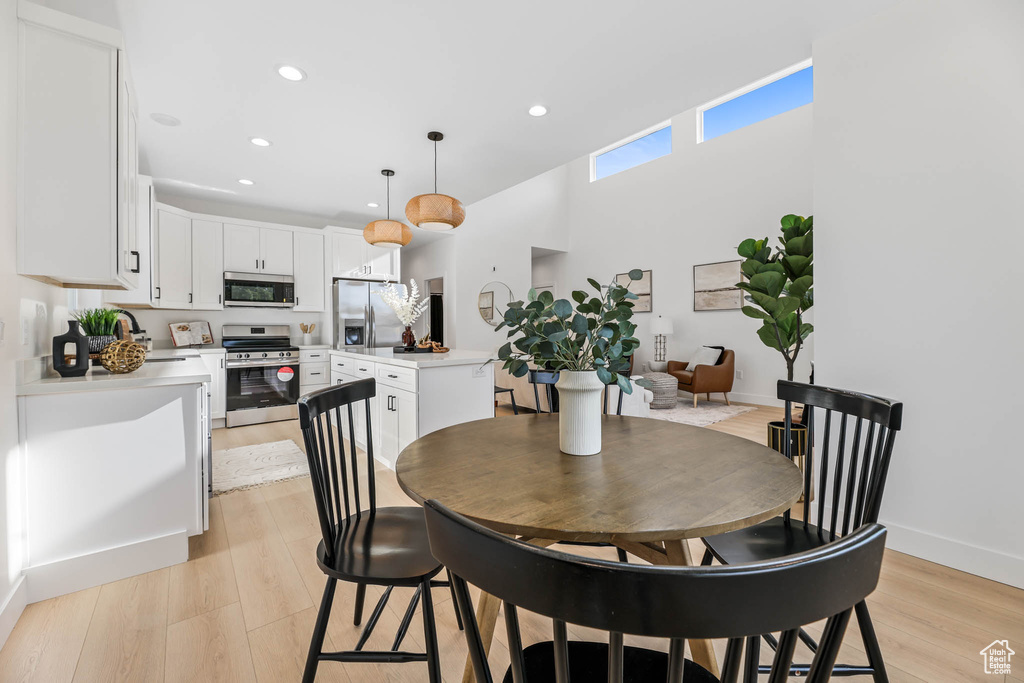 Dining space featuring recessed lighting and light wood-style flooring