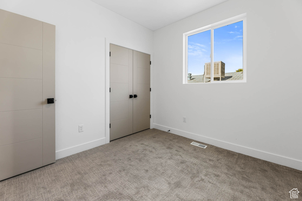 Unfurnished bedroom with baseboards and carpet