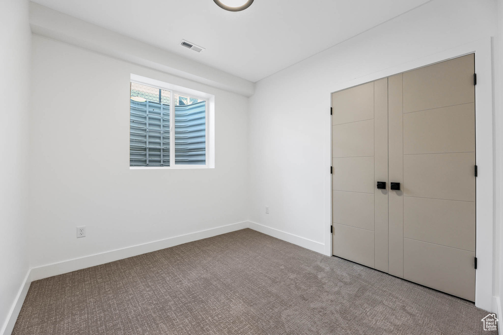 Unfurnished bedroom with carpet floors and a closet
