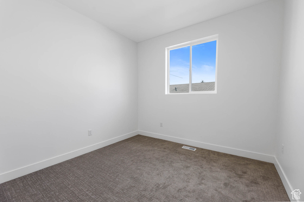 Empty room with carpet floors and baseboards
