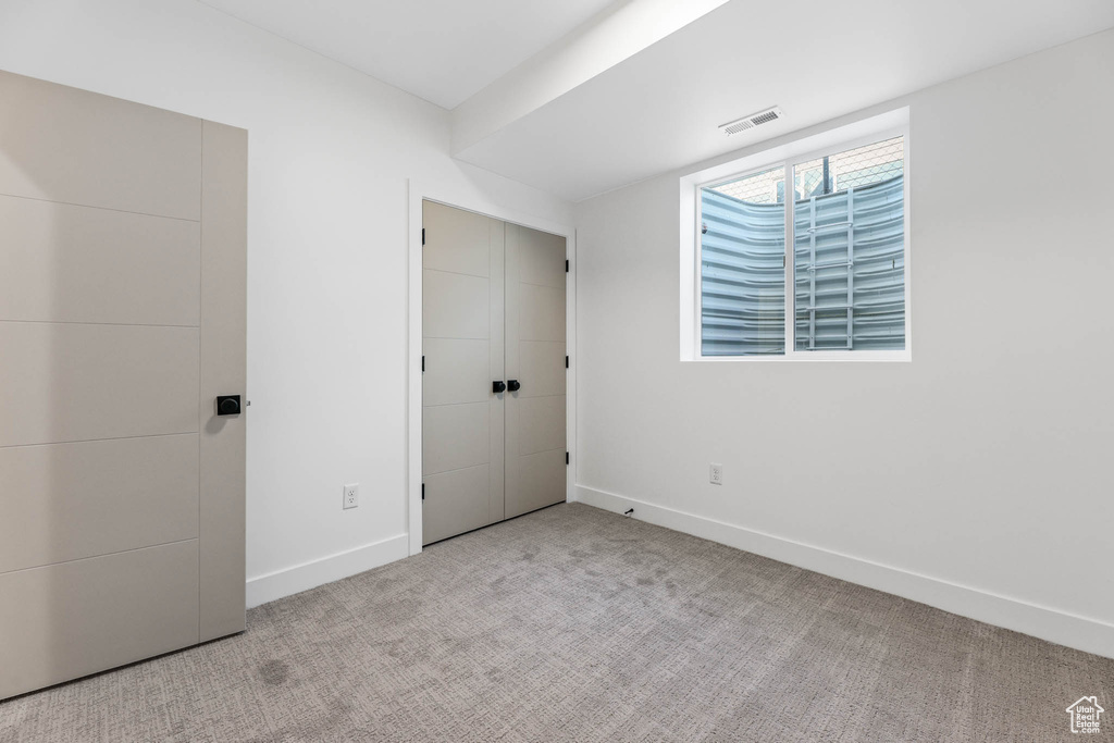 Unfurnished bedroom with baseboards and carpet