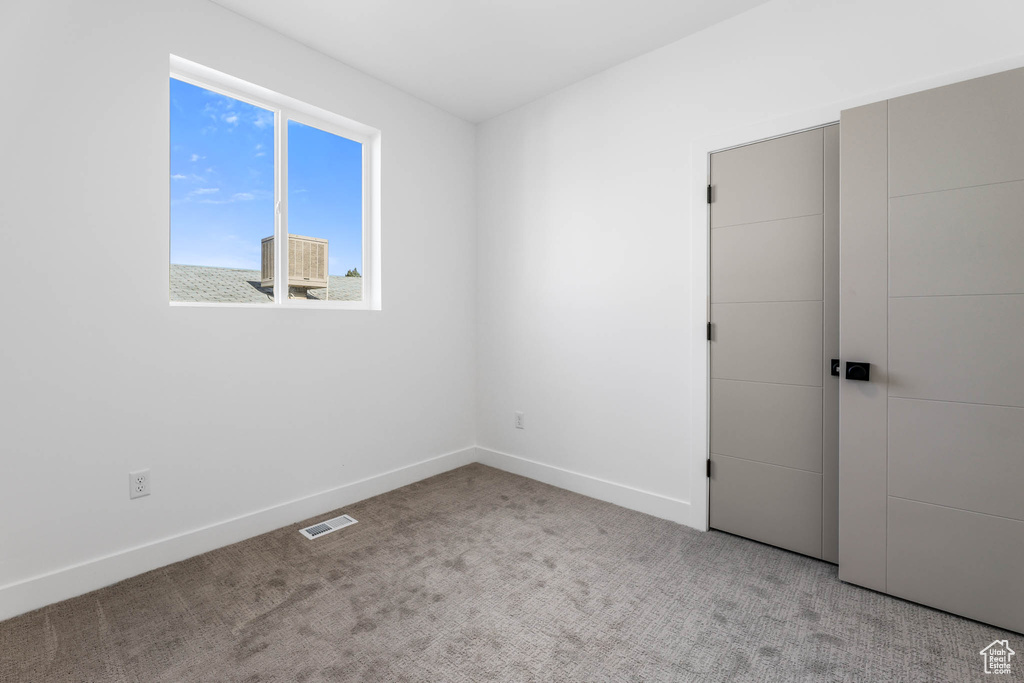 Unfurnished bedroom featuring carpet flooring and baseboards