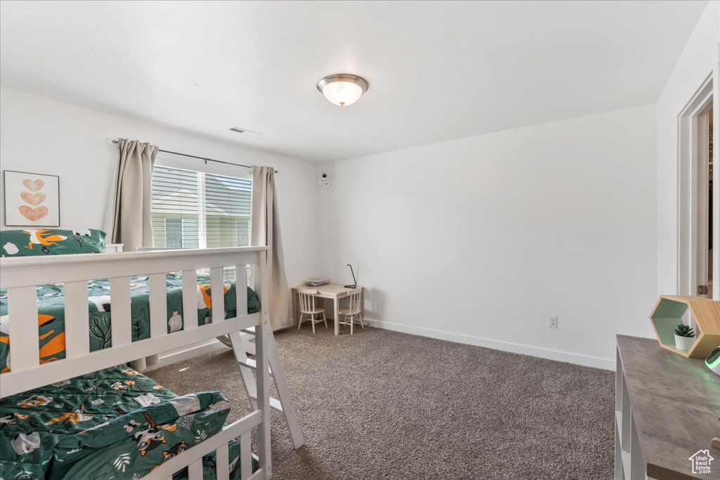 Carpeted bedroom with baseboards