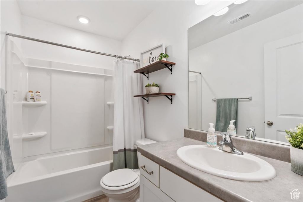 Bathroom featuring vanity and shower / bath combo