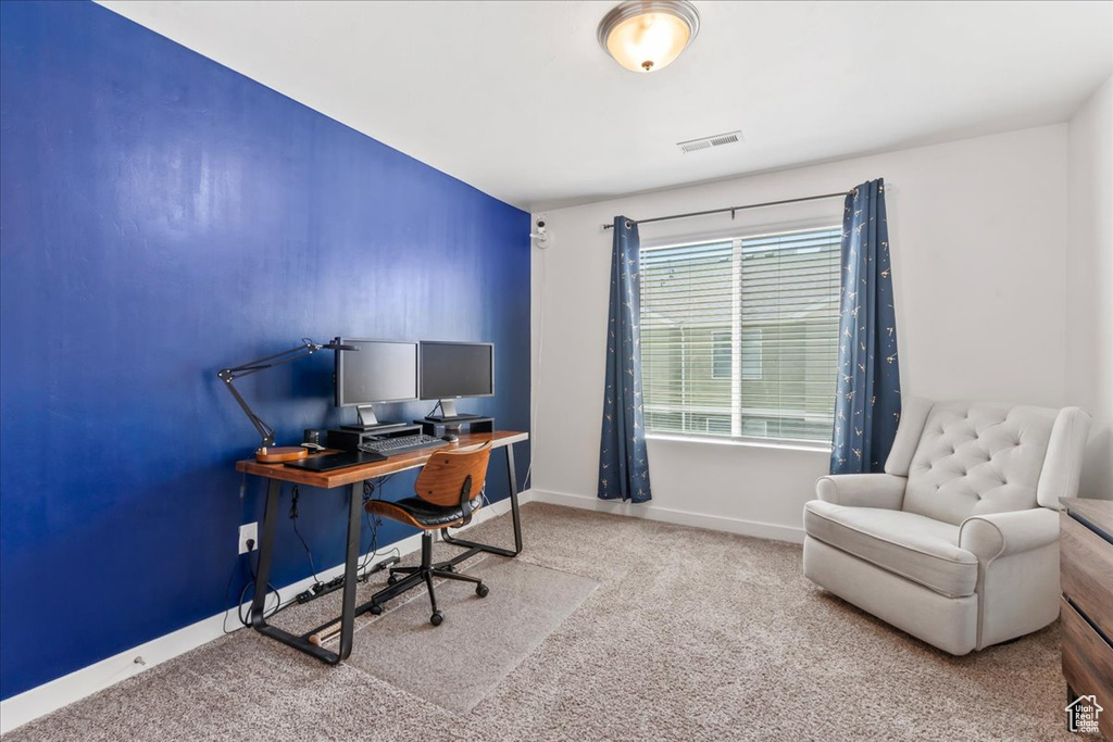 Carpeted office space featuring baseboards
