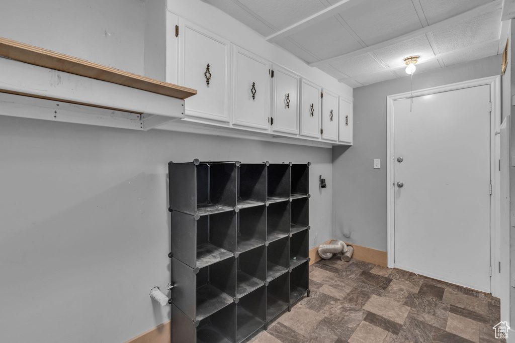 Washroom featuring dark stone finish floors and baseboards