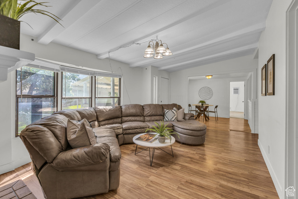 Living room with a chandelier and light wood-style floors