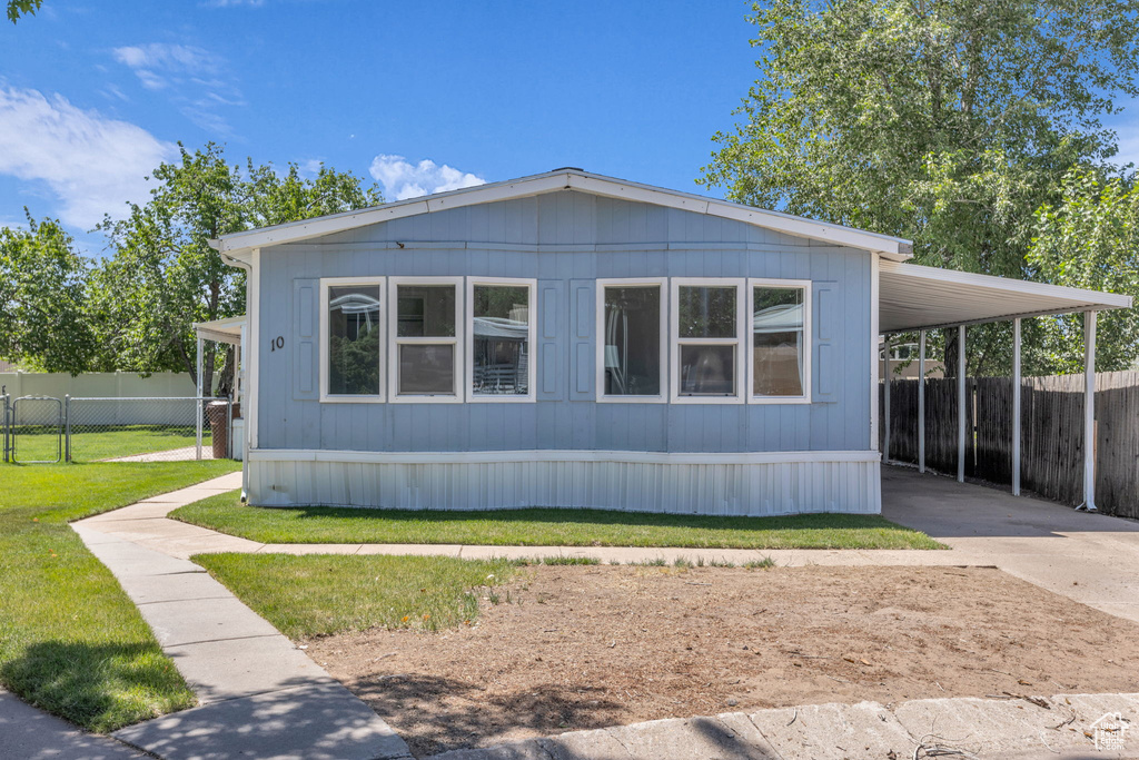 View of home's exterior featuring driveway and an attached carport