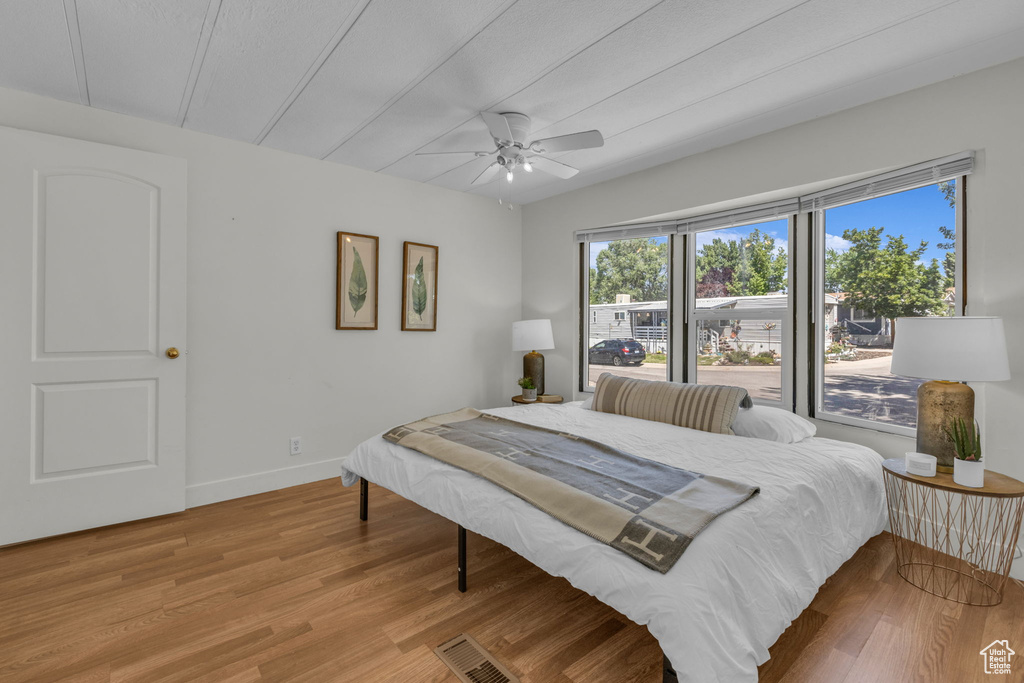 Bedroom featuring wood finished floors and a ceiling fan