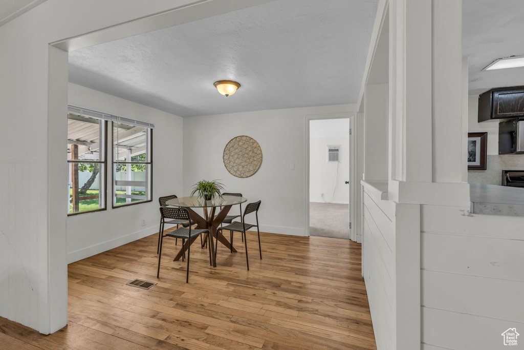 Dining room with light wood finished floors and baseboards