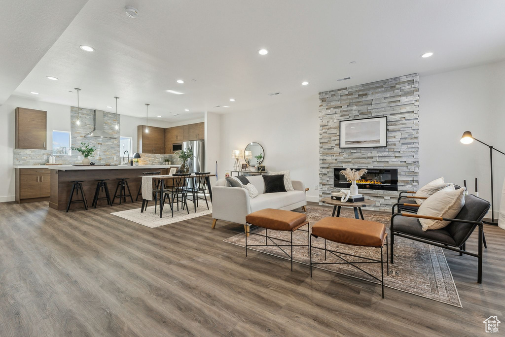 Living room featuring recessed lighting, wood finished floors, and a fireplace